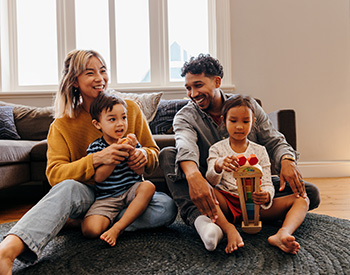 A photo of a family laughing at each other